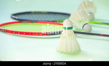Badminton shuttlecocks with rackets on a green background symbolizing the spirit of exercise and global competition the essence of athleticism and the Stock Photo