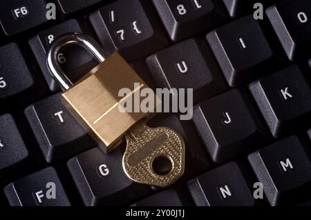 A padlock on top a computer keyboard to represent the concept of computer security Stock Photo