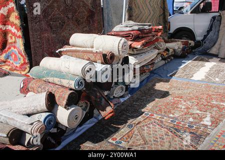 Persian Rug Display A view of several Persian throw rugs, on display at a local swap meet ...