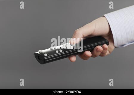 Business man hand holding television remote control and changing channel Stock Photo