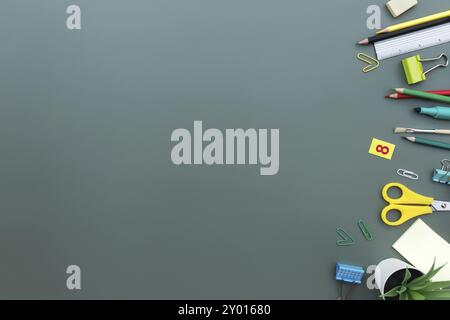 Back to school conceptual flat lay with different office supply objects on green background. Concept for primary and secondary school pupil. Scissors, Stock Photo