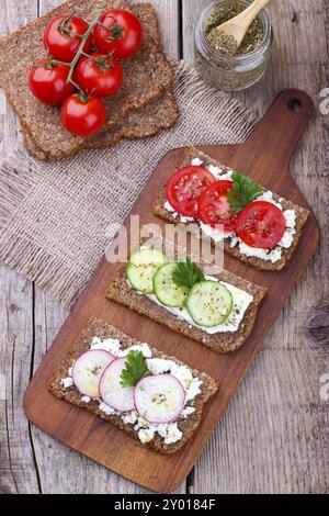 Vegetarian toast sandwich with vegetables, black bread, feta cheese, tomato, cucumber and radish Stock Photo