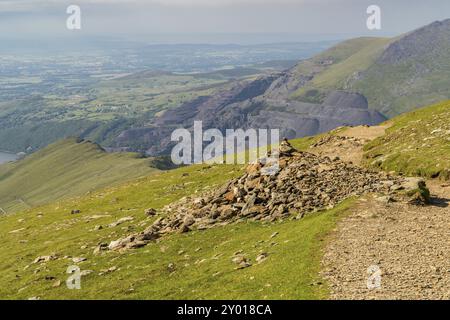 Walking down from Mount Snowdon on the Llanberis Path, Snowdonia, Gwynedd, Wales, UK, looking north towards Llyn Padarn and Llanberis Stock Photo