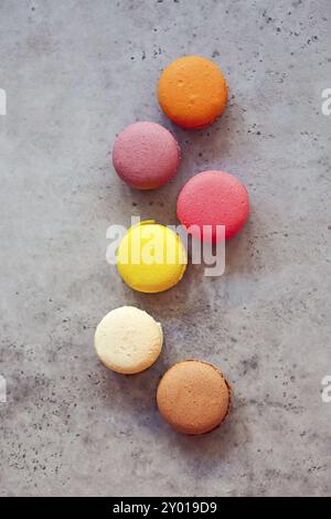 Stack of colorful French macarons on a dark rustic background, selective focus Stock Photo