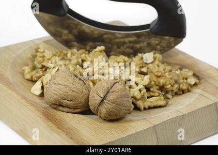 Peeled walnuts on a board with a weighing knife Stock Photo