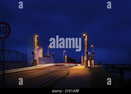 Road, which leads over a modern lift bridge, at night Stock Photo