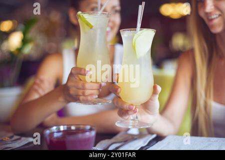 Two beautiful women having fun in a bar drinking cocktails Stock Photo