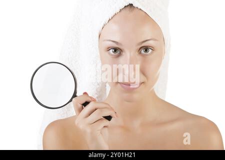 Woman with a towel wrapped around her head holding a loupe, isolated in white Stock Photo