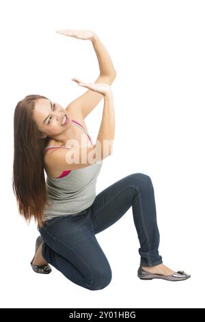 Struggling Asian woman kneeling under weight in casual clothes, arms extended supporting, getting crushed, pushing up against falling product placemen Stock Photo