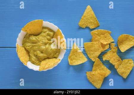 Nachos chips and salsa guacamole over a blue background seen from above Stock Photo