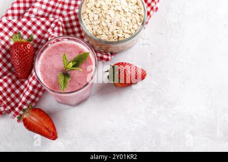 Strawberry milkshake or smoothie with oatmeal in a glass, top view copy space Stock Photo
