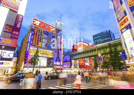 Tokyo, Japan, July 29, 2015: Hectic hustle and bustle of main street in Akihabara among bright neon billboards and store signs at blue hour on summer Stock Photo