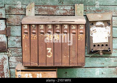 old mailboxes hanging on the wall Stock Photo