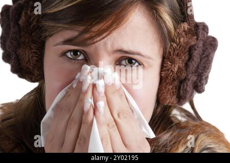 Pale sick woman with a flu, sneezing, in a white background Stock Photo