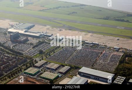 aerial view of Liverpool John Lennon Airport looking South across the terminal, car parking, runway & towards the Mersey Estuary Stock Photo