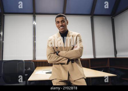 Businessman standing alone in a modern workplace. Stock Photo