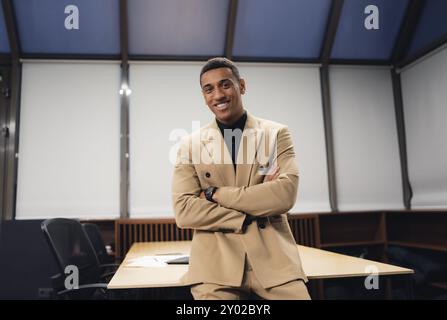 Businessman standing alone in a modern workplace. Stock Photo