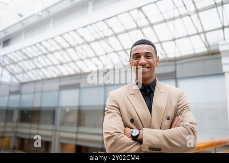 Businessman standing alone in a modern workplace. Stock Photo