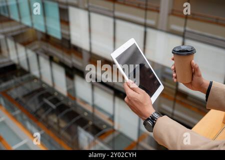 Businessman standing alone in a modern workplace. Stock Photo