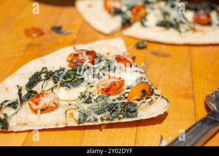 A closeup view of a slice of rustic Mediterranean flatbread. Stock Photo