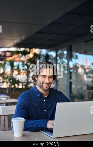Happy young business man entrepreneur using laptop working outdoors. Stock Photo