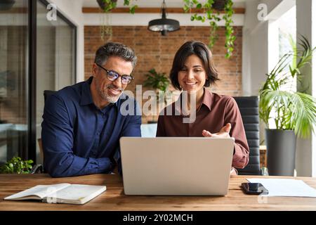 Professional business man and woman executives using laptop working in office. Stock Photo