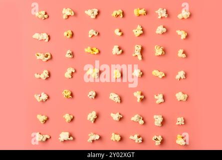 Crispy popcorn on pink background Stock Photo