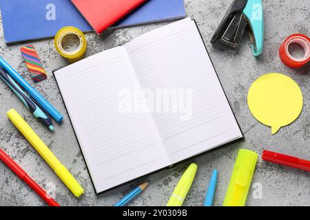 Notebooks with different stationery on grunge grey background Stock Photo