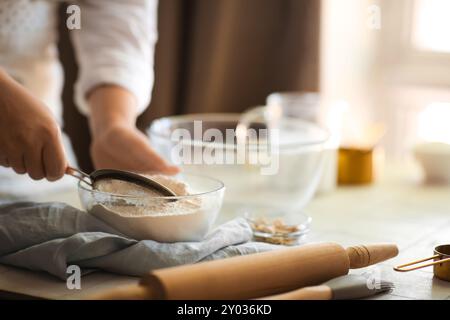 Woman preparing traditional cinnamon rolls in kitchen Stock Photo