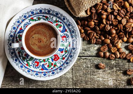 Turkish coffee concept, cup of coffee with coffee beans on rustic background Stock Photo