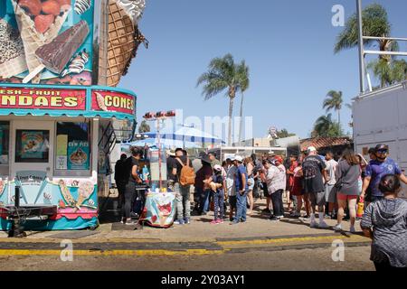 Garden Grove, California, United States - 05-30-2022: A view of a people waiting in line at a food concession stand, seen at the Strawberry Festival. Stock Photo