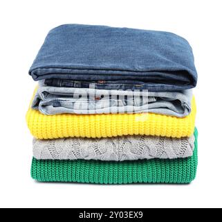 Stack of sweaters and jeans isolated on white Stock Photo