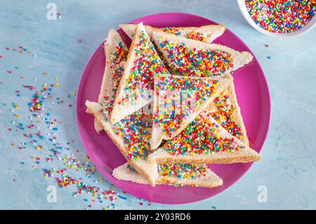 Slices of fairy bread on a plate. Fairy bread is a traditional Australian party food Stock Photo