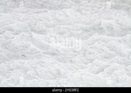 The rough, uneven surface of the white snow. Abstract light background for Christmas and New Year. Stock Photo