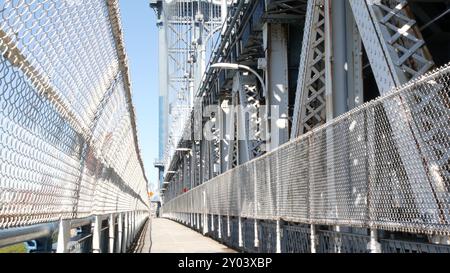 Manhattan Bridge to Brooklyn Dumbo. New York City symbol, USA travel destination. Architecture of United States, tourist landmark. Cable-stayed bridge. Pedestrian path perspective. Stock Photo