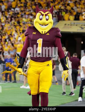 Arizona State Sun Devils mascot “Sparky” watches painter paint a ...