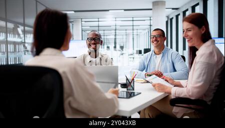 Group Of Multi Ethnic Businesspeople Discussing Together In Office Stock Photo