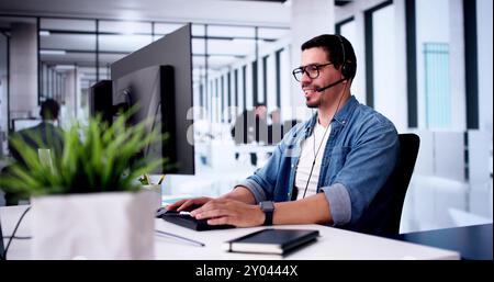 Call Center Operator Sitting Working At Office Stock Photo