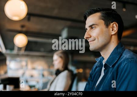Smiling male programmer working in office Stock Photo
