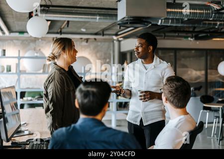 Male and female computer programmers discussing ideas at office Stock Photo