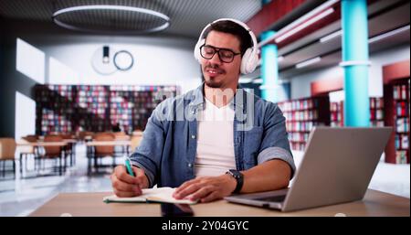 Student Man Thinking At Library While Using Univercity Laptop Stock Photo