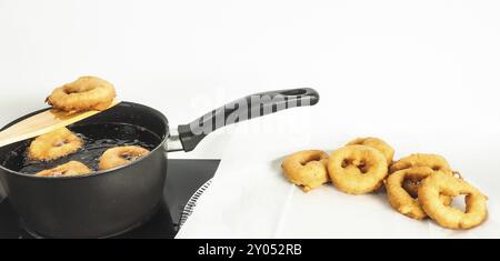 Fresh made doughnuts from boiling hot oil onto baking paper Stock Photo