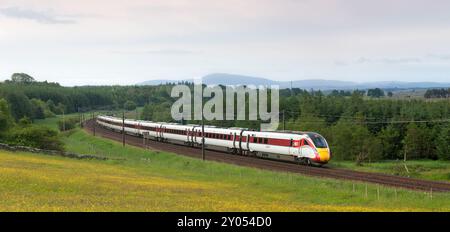 LNER Hitachi class 801 Azuma train passing the countryside at Auchengray, Scotland, UK Stock Photo