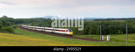 LNER Hitachi class 801 Azuma train passing the countryside at Auchengray, Scotland, UK Stock Photo