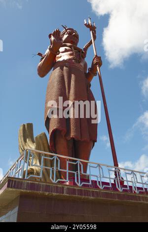 Photo from street level upward view of larger-than-life figure of god