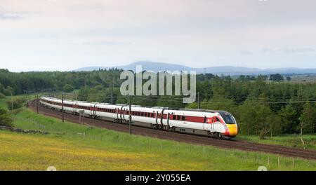 LNER Hitachi class 801 Azuma train passing the countryside at Auchengray, Scotland, UK Stock Photo