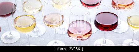 Wine glasses at a tasting panorama. Rose, red, and white wine, drinks on a table. An assortment of wines of many different colors, panoramic banner fo Stock Photo