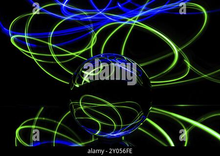 Fascinating light paintings can be created in a completely dark room with the help of just a few utensils. All you need is a mirror on which the glass Stock Photo