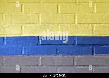 Yellow blue and grey wall made from bricks background Stock Photo