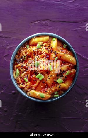 Rabokki, tteokbokki or topokki with ramen, Korean street food, spicy rice cakes in red pepper gochujang sauce, shot from the top Stock Photo